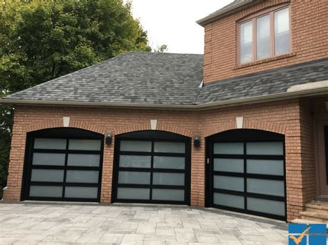 "Trusted garage door service professionals working on a residential garage door in Montvale.