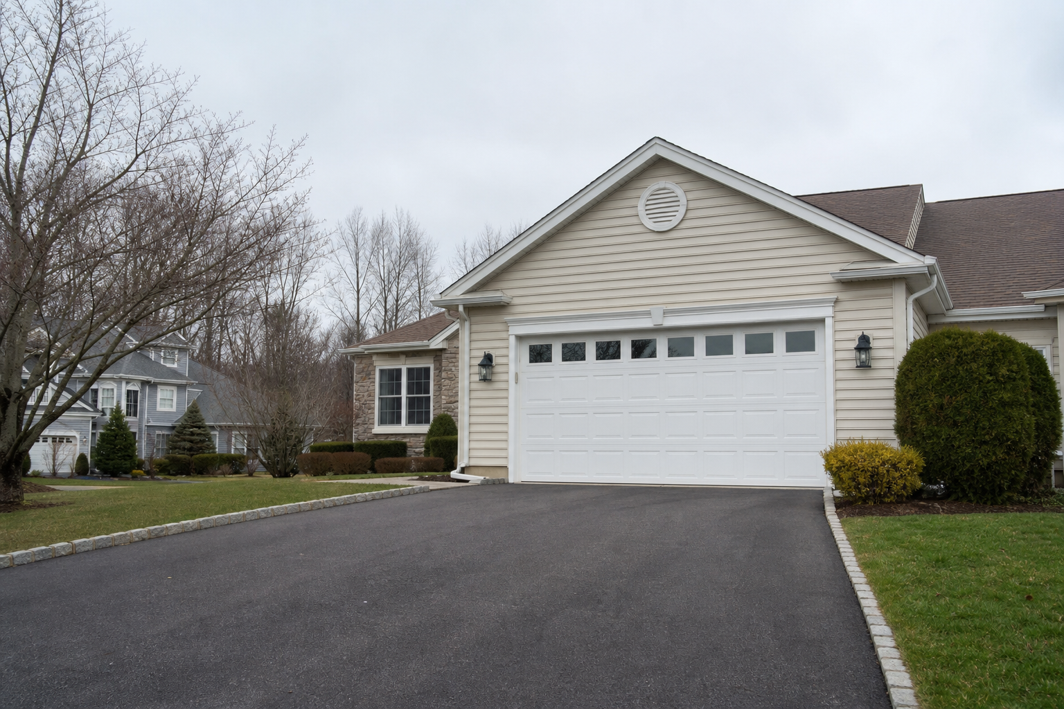 Suburban Montvale garage exterior with a closed garage door in natural daylight