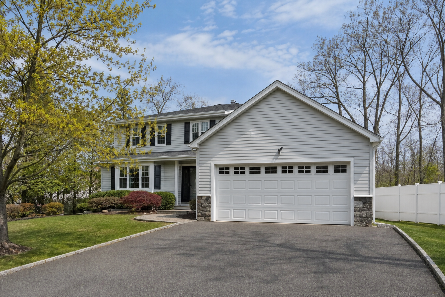 Suburban Montvale home with a visible garage door in natural daylight